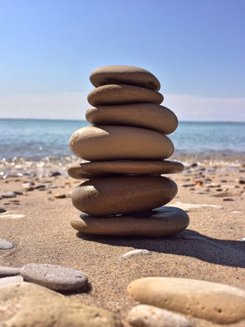 rock - Object, tranquil Scene, beach, sunlight, stack, water, arrangement, nature, horizon over water, stability, pebble, clear sky, land, coastline, outdoors
