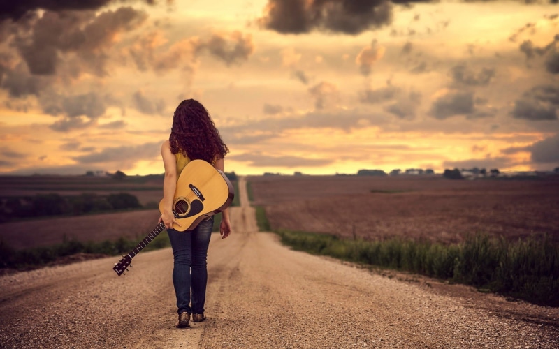 musical instrument, guitar, real people, nature, cloud - sky, land, music, outdoors, focus on foreground, leisure activity, sunset, string instrument, road