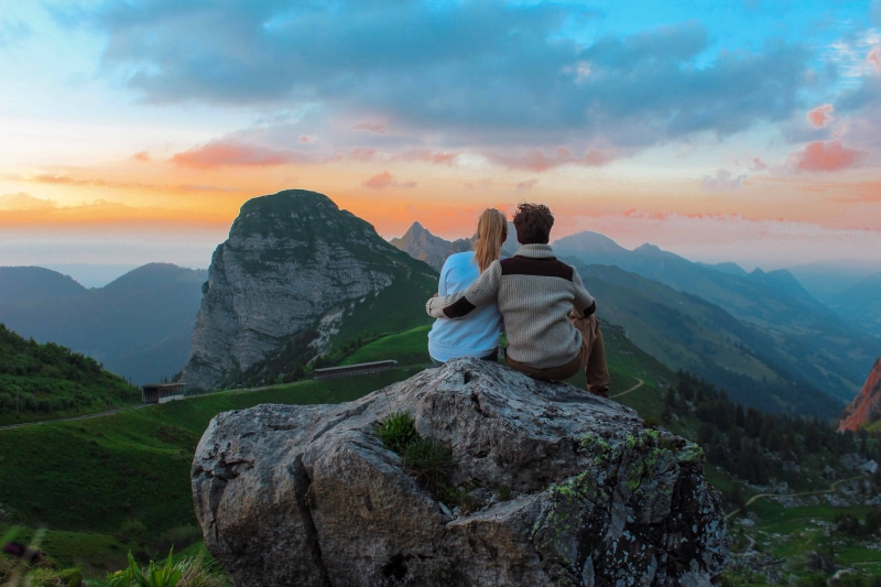looking at view, couple, people, man, sitting, facing, beauty in nature, looking, outdoors, view, geneva, environment, mountain, 2K, positive emotion