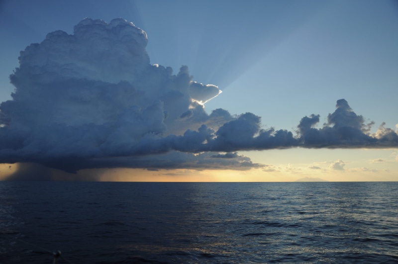 waterfront, outdoors, sunbeam, no people, horizon, beauty in nature, idyllic, horizon over water, power in nature, non-urban scene, storm, sea, scenics - nature