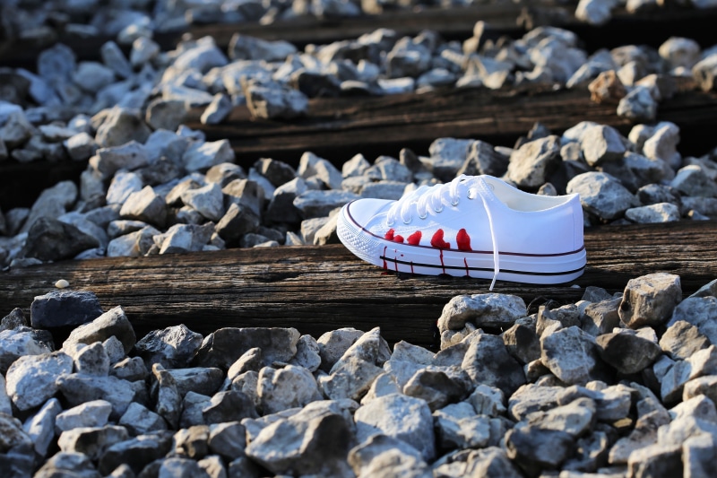 pressure to be perfect, selective focus, mode of transportation, water, bloody sneaker on railway, outdoors, solid, stop cyber bullying, stop teenager suicide