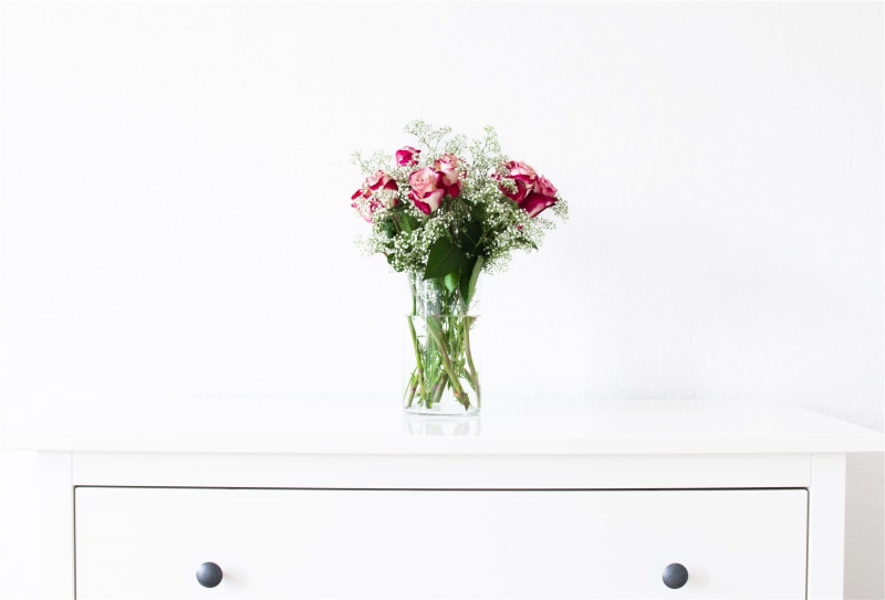 glass, roses, centerpiece, beauty in nature, pink, nature, white, flowering plant, white color, vase, flower head, furniture, table, plant, flowers, close-up