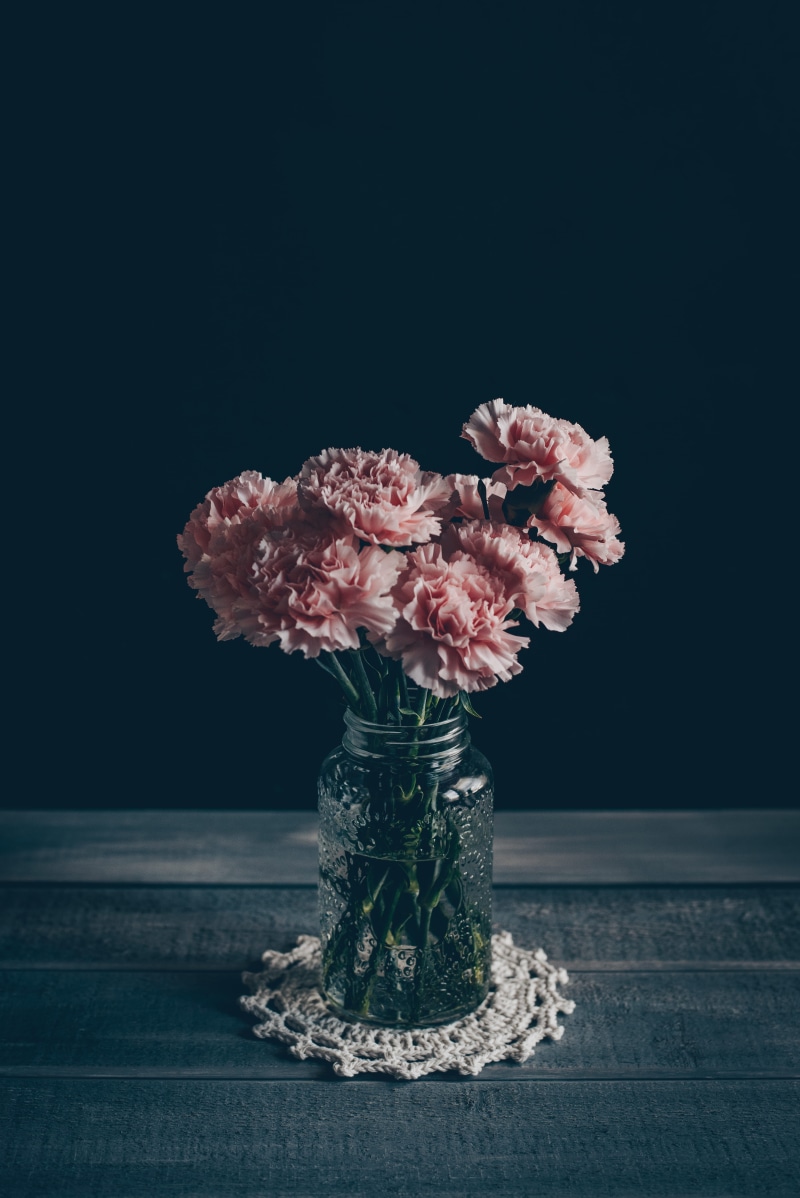 indoors, moody, table, crochet, bunch of flowers, close-up, black background, simple, flower arrangement, 5K, flowering plant, carnation, freshness, flower