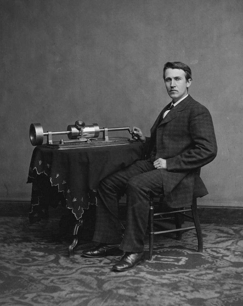 casual clothing, looking away, progress, young men, chair, tool, inventor, young adult, scientists, phonograph, man, music, full length, metal, black And White