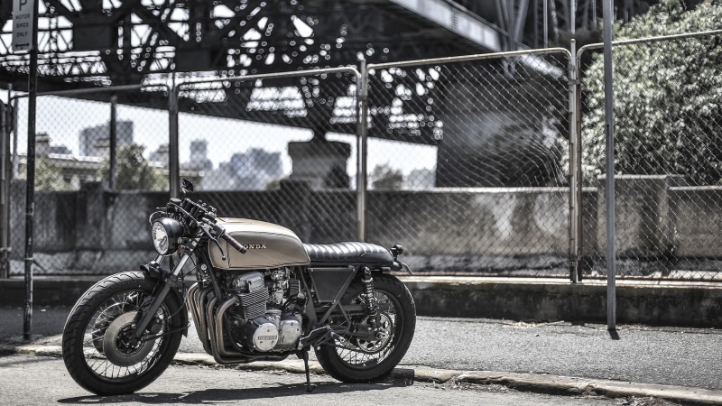 mode of transportation, stationary, day, no people, chainlink fence, safety, Honda, boundary, transportation, focus on foreground, 2K, outdoors, city