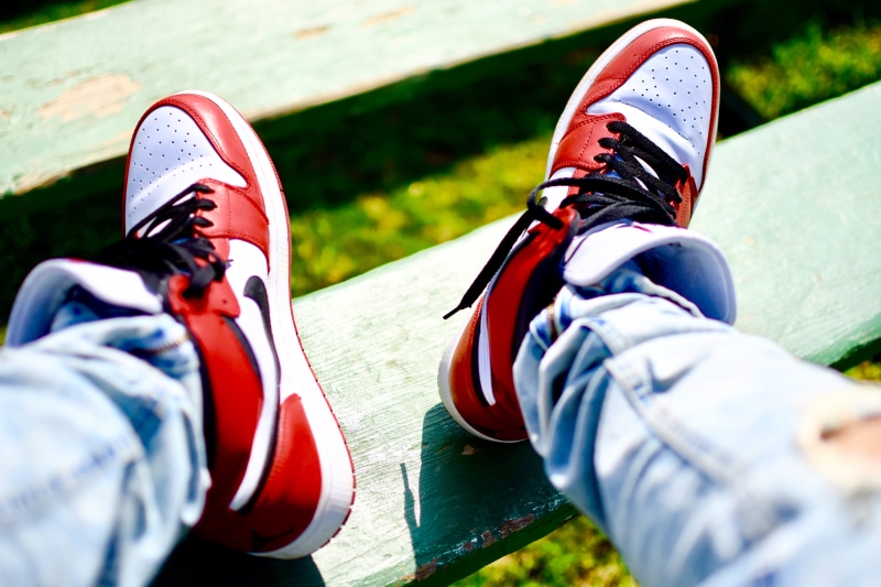 real people, low section, personal perspective, outdoors, body part, human foot, human body part, leisure activity, sneakers, black, kicks, high, person