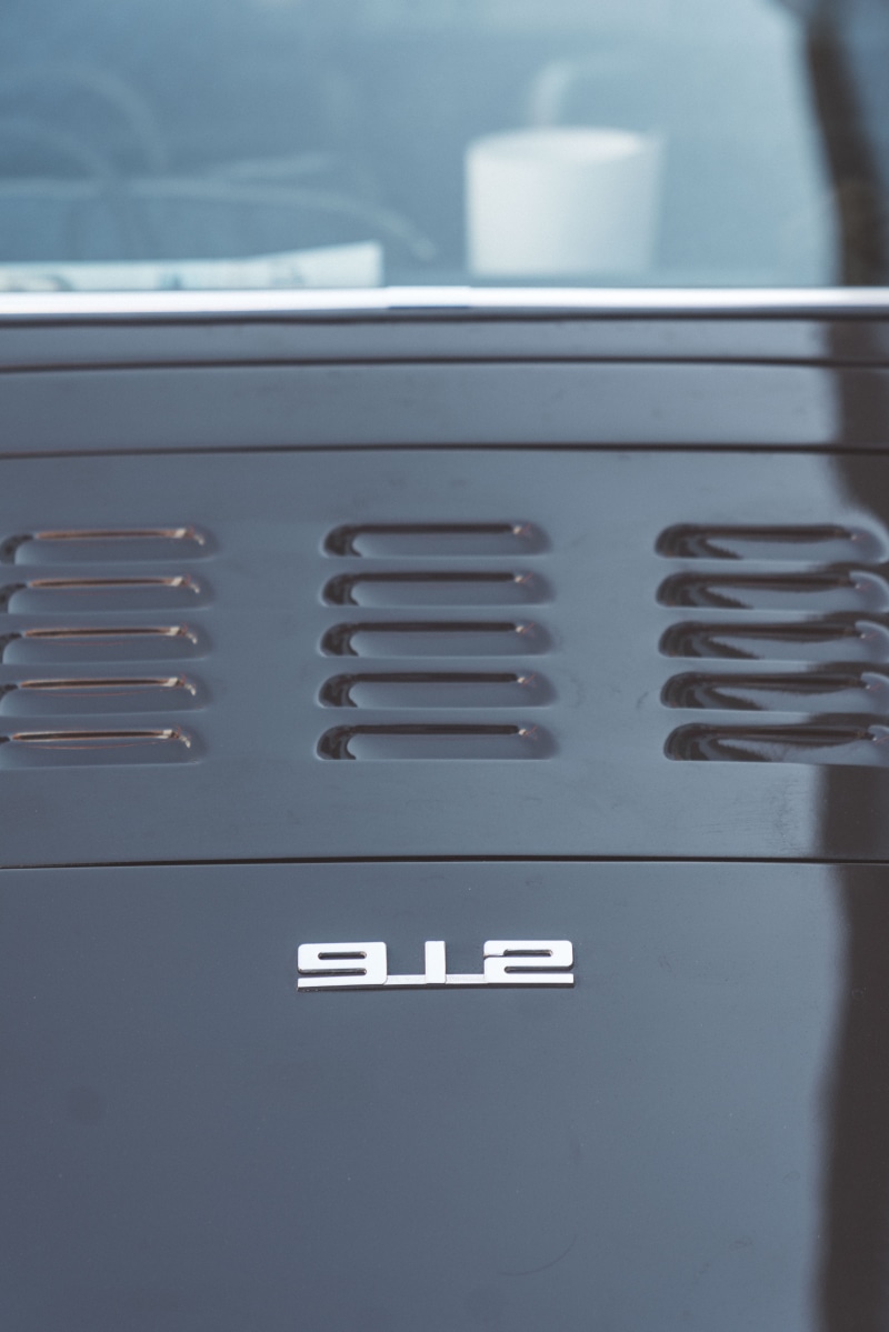 furniture, no people, machine, focus on foreground, tire, sign, indoors, dishwasher, urban, day, text, control panel, close-up, porsche, coil, rotor, appliance