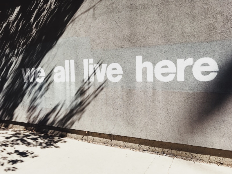 gray, housing, here, text, we live here, no people, 625 n kingsbury st, city, sunlight, urban, shadow, clothing, building, building exterior, wall, capital letter