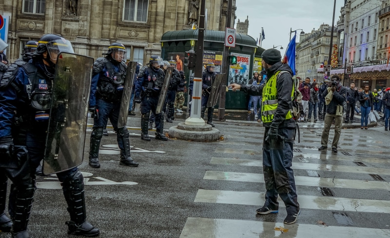 helmet, rain, human, urban, town, downtown, clothing, asphalt, road, law, pedestrian, real people, france, outdoors, person, 2K, building exterior, paris