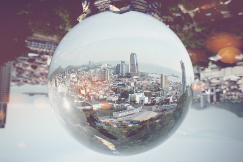 reflection, transparent, sunlight, sphere, focus on foreground, no people, apparel, skyscraper, sky, office building exterior, helmet, city life, urban