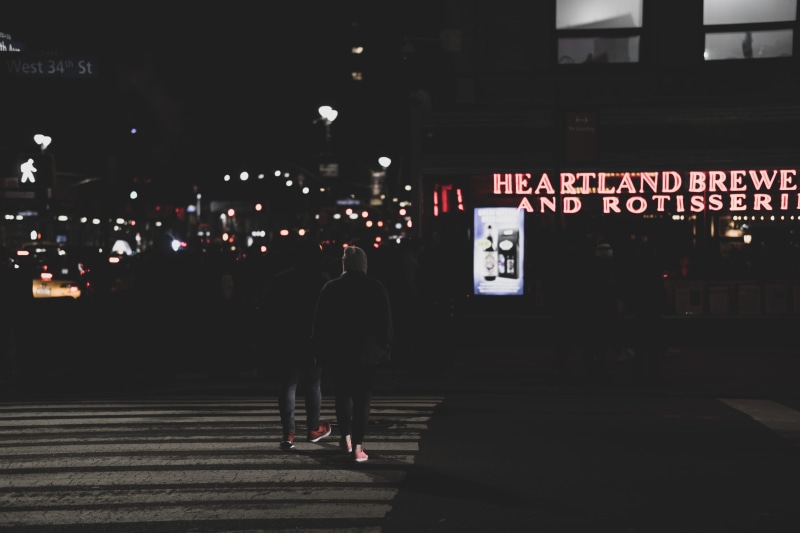 street, sleeve, metropolis, rear view, shoe, lifestyles, text, night, built structure, tarmac, building exterior, outdoors, word, communication, sign, walking