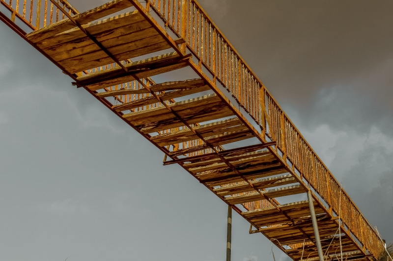 low angle view, metal, nature, no people, bridge - man made structure, built structure, industry, destroyed, disconnection, rusty, connection, tall - high