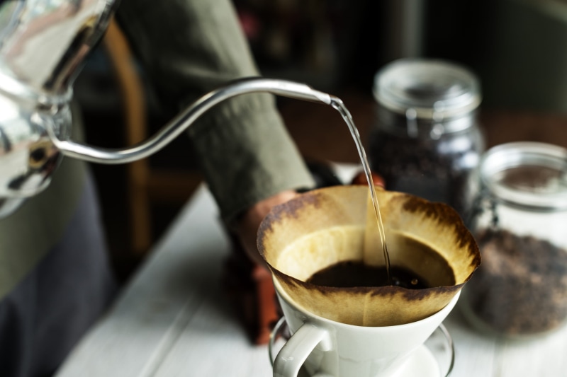 hand, barista, coffee - drink, coffee cup, beans, water, 1080P, roasted, beverage, blur, caffeine, focus on foreground, dark, photography, indoors, wood - material