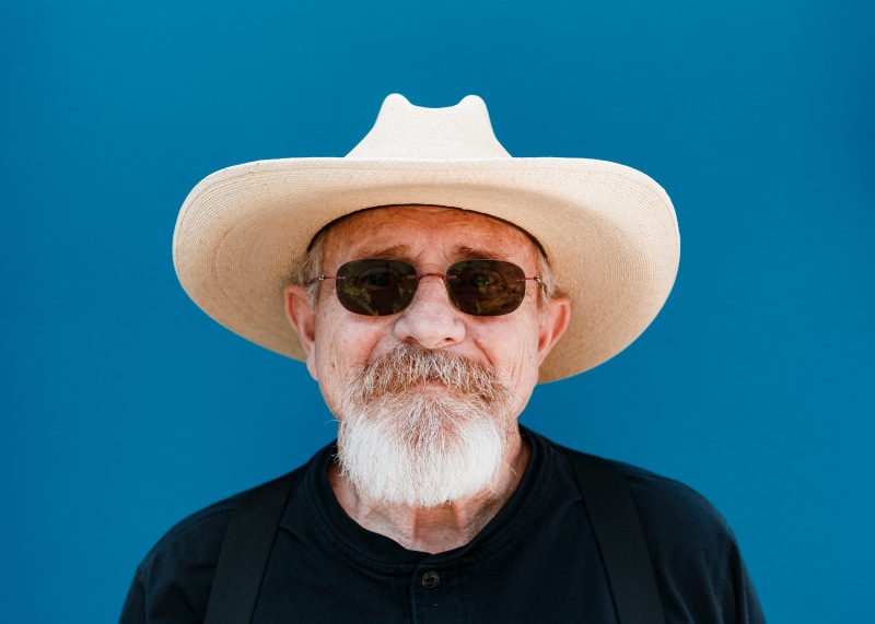 aviator, gray Hair, humor, people, person, males, taking, hat, smiling, style, photo, looking At Camera, crew neck, studio shot, front view, blue background