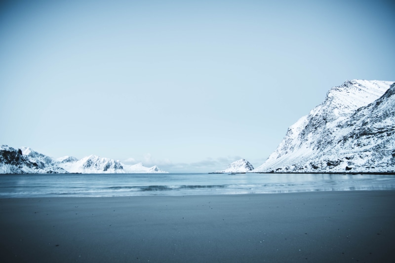 mountain, adventure, outdoors, mountains, scenics - nature, snow, ice, beauty in nature, mountain range, photography, sea, haukland beach, iceberg, clear sky