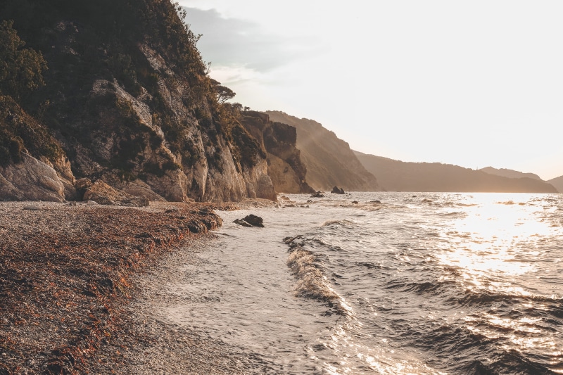 dirt road, beauty in nature, brown, solid, road, rocky coastline, no people, tranquility, sky, 4K, rock, promontory, day, body, scenics - nature, water