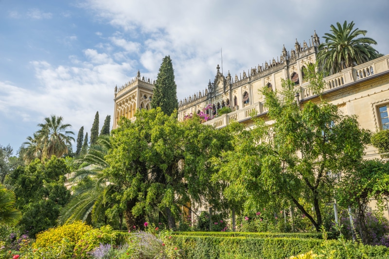 history, summer, cloud - sky, italian, famous, tourism, low angle view, Flowers, old, lombardy, built Structure, Isola Del Garda, blue, vacation, sky, growth
