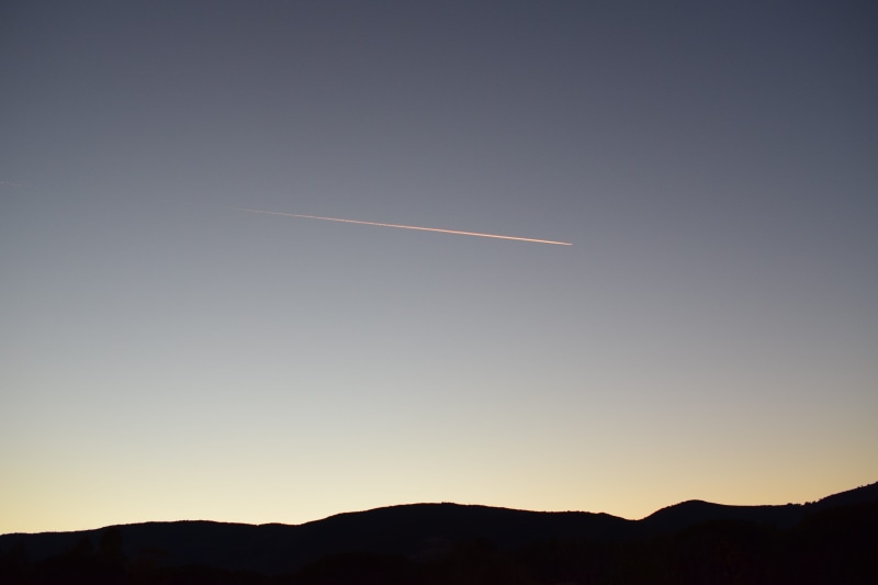 copy space, sunset, no people, motion, sky, low angle view, airplane, light, plane, italy, beauty in nature, mountain, mountains, scenics - nature, silhouette