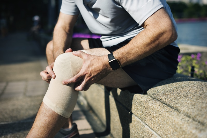 human hand, seating, holding, massage, painful, nature, knee, man, hand, fitness, muscle, outdoors, focus on foreground, hurt, watch, sunlight, westerner