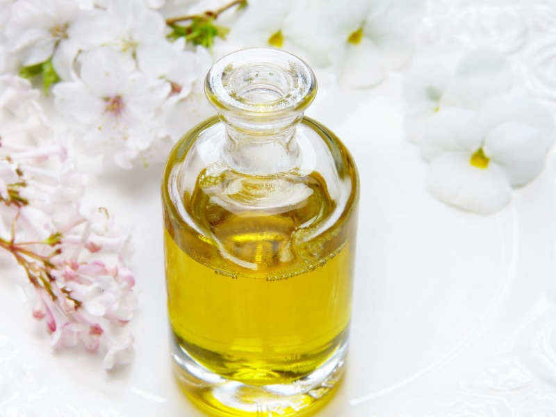 scented, perfume, aromatherapy oil, flower, indulgence, cosmetics, glass - material, wellbeing, health, transparent, flowers, care, bottle, luxury, no people