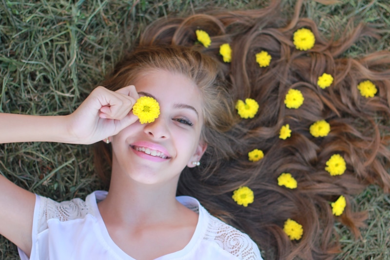 yellow, daylight, emotion, pose, holding, summer, flowering plant, 5K, model, fun, happiness, lying, smiling, freshness, directly above, plant, one person