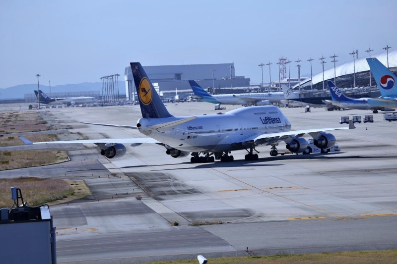 stationary, aerospace industry, aircraft, kansai international airport, business, boeing 747, travel, day, air vehicle, road, mode of transportation, nature