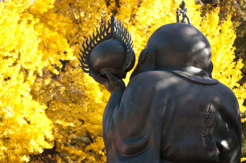 male likeness, oriental, zen, bronze, outdoors, kinki, 2K, waist up, religious, human representation, rear view, hyogo, creativity, ancient, yellow, japan