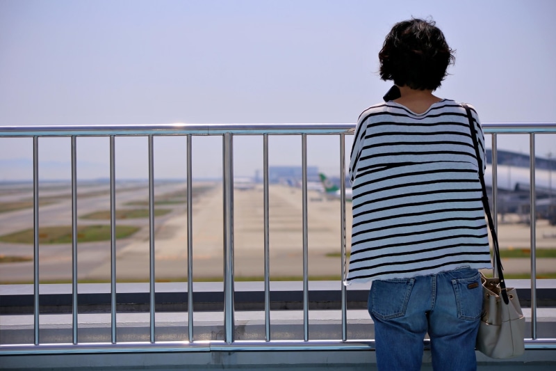focus on foreground, adult, lifestyles, railing, sky, water, young adult, nature, striped, rear view, 1080P, women, three quarter length, kansai international airport