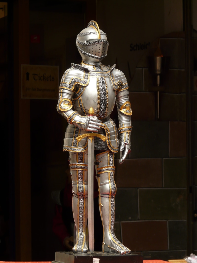 armor, black background, place of worship, warrior, no people, gold colored, holding, indoors, spirituality, silver knight, gold, battle, history, male likeness