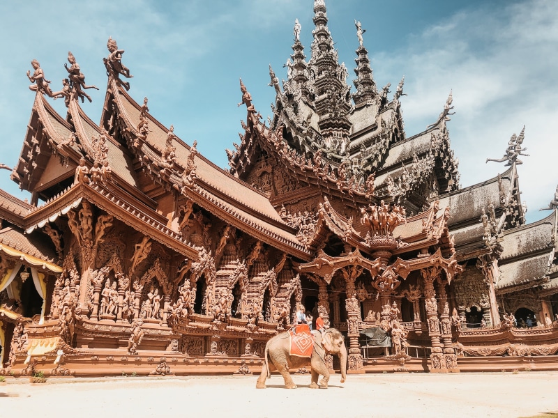 column, riding, elephant, building exterior, near, religion, person, the past, history, worship, steeple, travel destinations, human, pagoda, mammal, one animal