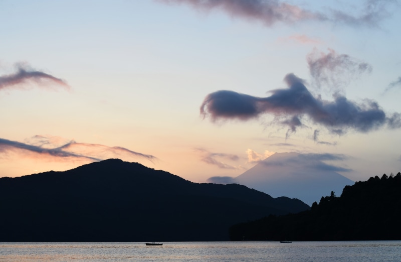 mountain, cloud - sky, smoke, sky, boat on water, lake ashi, calm, sunset, hill line, waterfront, outdoors, daytime, sea, tranquil scene, body, nature