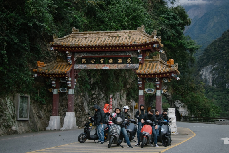 clothing, real people, building exterior, adult, vespa, large group of people, porch, machine, men, place of worship, architecture, person, helmet, parking