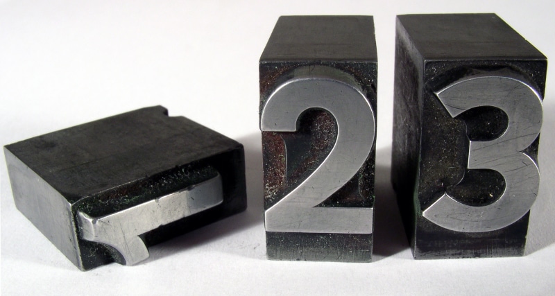stack, letterpress, series, indoors, lead, close-up, old, 123, 1, wood - material, communication, still life, white color, no people, black color, blocks