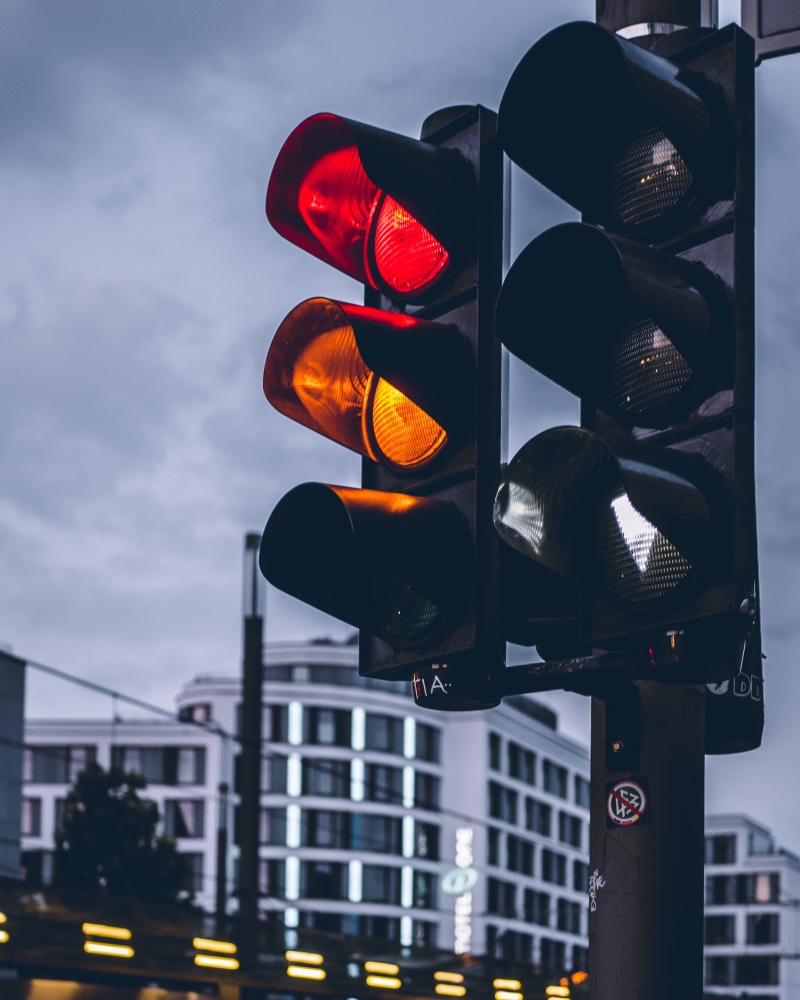 red light, low angle view, germany, orange, sky, office building, gate, built structure, cloud - sky, text, no people, headlight, guidance, traffic light