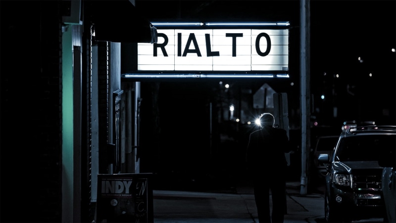 rear view, near, sign, illuminated, city life, architecture, street, one person, Rialto, entertainment, standing, night, person, transportation, dark, signage