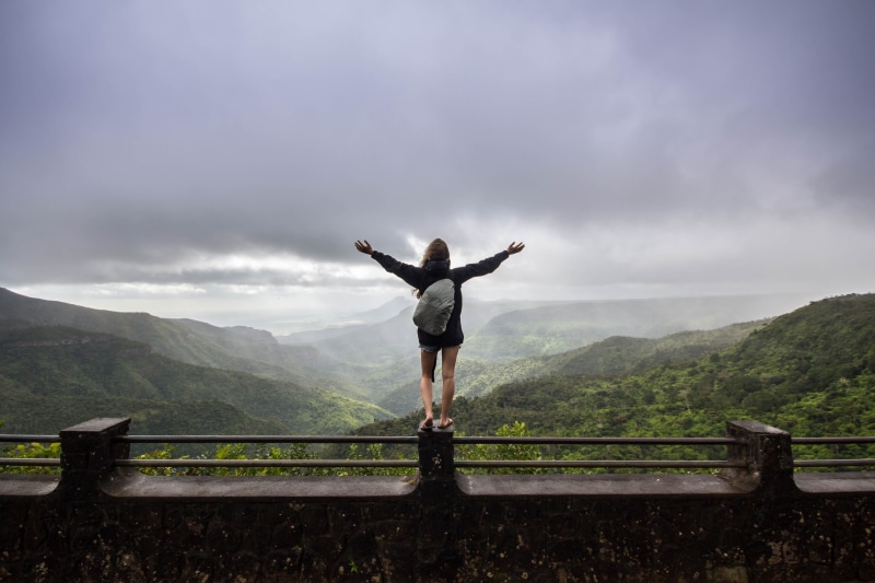 non-urban scene, gorges viewpoint, real people, banister, green, person, standing, concrete, weather, maritius, cloud - sky, arms outstretched, human, rear view