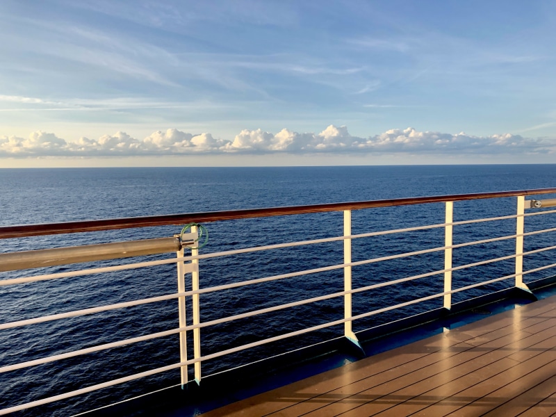 horizon over water, sky, railing, calm, cloud - sky, relax, boat deck, horizon, flooring, hardwood, blue, porch, beauty in nature, electrical device, outdoors
