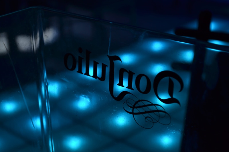 indoors, lighting equipment, sign, alphabet, text, ampersand, logo, light, art, neon, banner, close-up, symbol, crime, bottle, emblem, no people, night