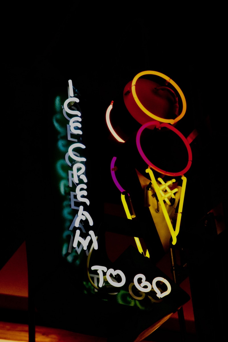 handwriting, drink, art and craft, creativity, logo, glass, indoors, representation, neon, illuminated, alphabet, horn, yellow, night, cornet, calligraphy