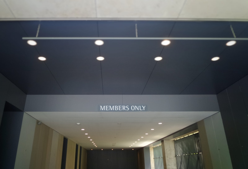 no people, vehicle, black, conference room, door, text, concrete, wall, sign, office, meeting room, room, flooring, ceiling, recessed light, furniture
