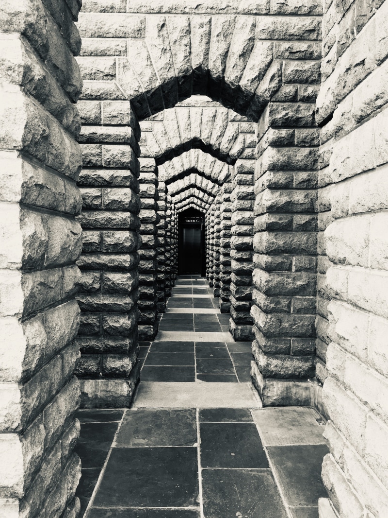 dock, walkway, tunnel, dungeon, day, direction, aisle, old, corridor, arch, stone material, building, the way forward, prison, sunlight, brick, no people