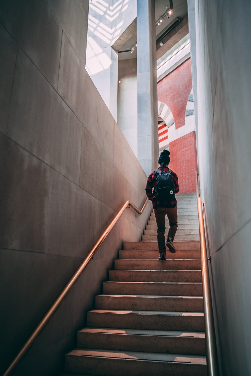 staircase, banister, flare, casual clothing, carrying, warm clothing, steps and staircases, leisure activity, moving up, lifestyles, hardwood, flooring