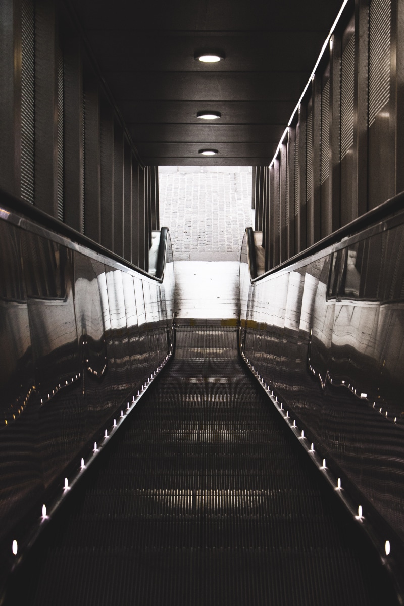 handrail, illuminated, grayscale, subway, underpass, public transportation, absence, direction, wall - building feature, basement, city, ceiling, railing