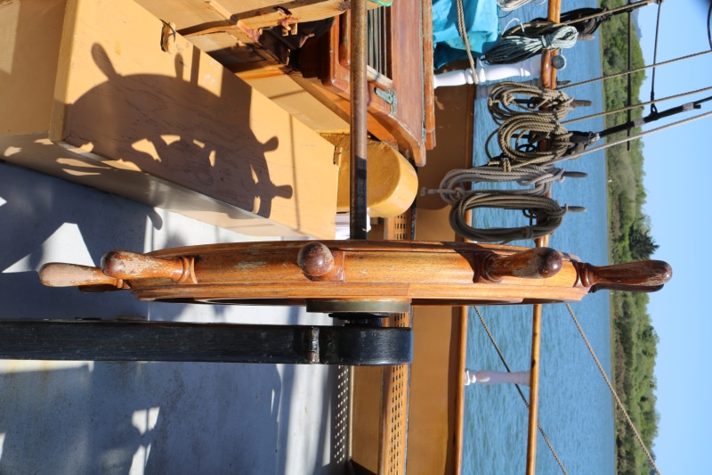 porch, hook, tire, vehicle, vessel, day, nautical vessel, hardwood, rust, built structure, no people, railing, plywood, outdoors, metal, handrail, banister