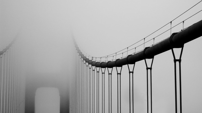 transportation, suspension bridge, copy space, bridge - man made structure, bridge, built structure, low angle view, mist, outdoors, railing, hanging, sky