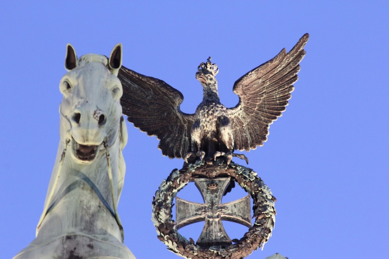 animal body part, animal representation, brandenburg, landmark, day, low angle view, representation, history, capital, clear sky, blue, no people, animal wildlife