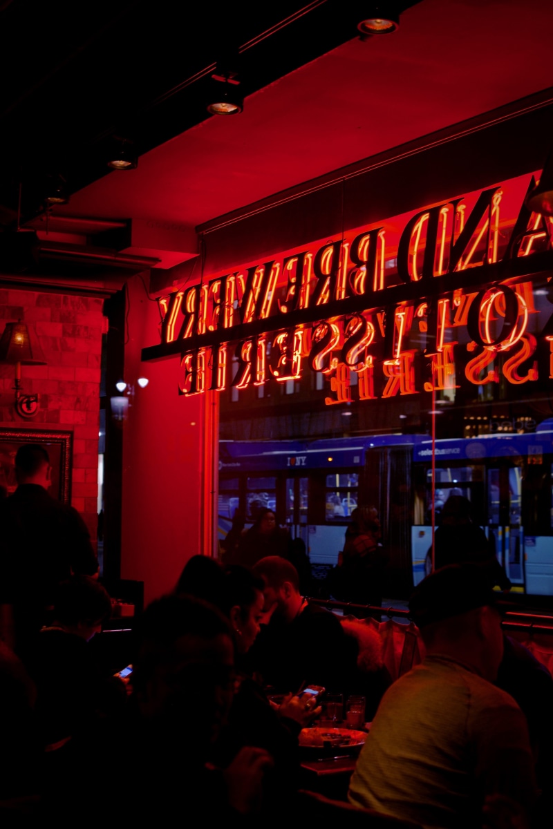 retail, adult, cafe, nightlife, night life, brewery, empire state building, person, restaurant, red, human, pub, architecture, light, group of people, background