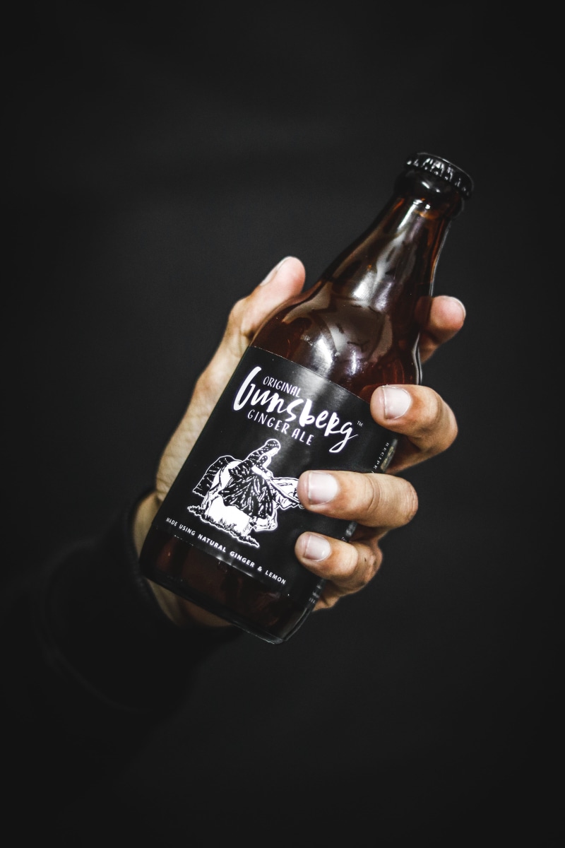 beverage, hand, ginger, adult, gunsberg, holding, close-up, container, in, indoors, human body part, product, beer bottle, food and drink, bottle, drink