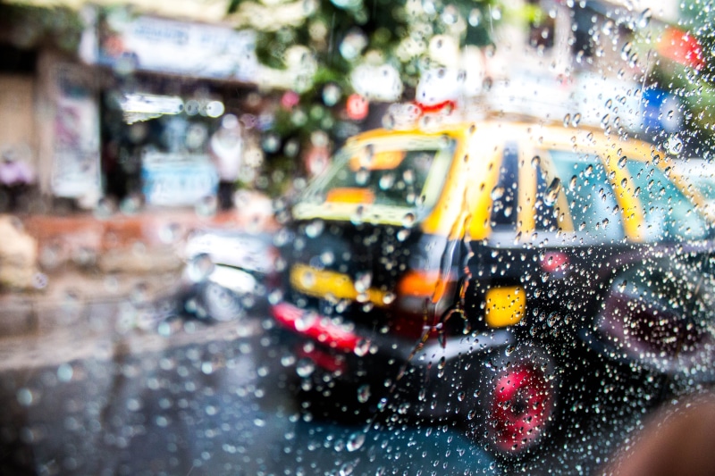 driver, city, outdoors, window, mumbai, travel, india, life, mode of transportation, drops, yellow taxi, taxi, raindrops, motor vehicle, road, land vehicle