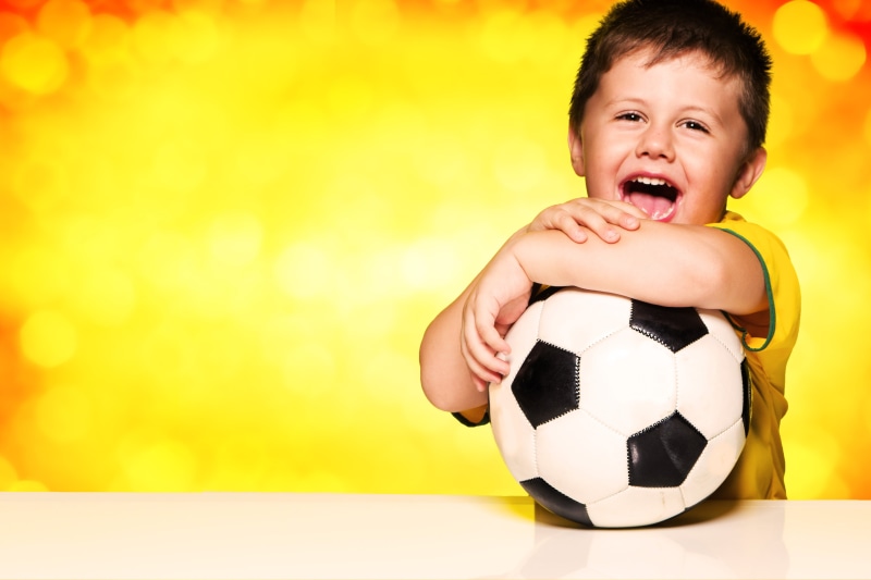 white, holding, joy, smiling, lifestyles, mouth open, soccer Ball, activity, playful, excitement, child, 5K, sports equipment, black, happiness, caucasian Ethnicity